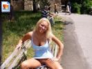 Hot blonde chick gives us a view of her pussy while seated on a park bench