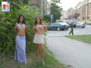 Two very sexy young girls flash their titties on the sidewalk
