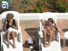Two young teens going topless at the pool