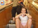 Naughty girl shows her snatch on escalator