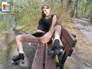Hot rollerskating girl spreads her legs on a park bench and shows cunt