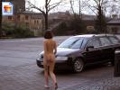 Naughty girl shows off her ass on a parking lot