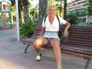 Short haired milf shows off her snatch on a bench