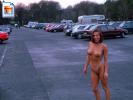 Big boobed beauty walks around naked at a parking lot