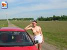 Naughty amateur poses topless in the countryside