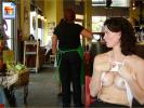 Amateur brunette shows her tits in restaurant