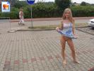 Very sexy blonde teen flashing her pussy on a parking lot with people watching