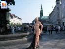 Big boobed blonde poses naked on the square