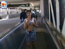 Naughty girl flashes her boobies at the airport