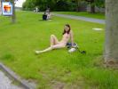 Naughty girl lays around in the grass naked