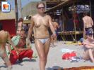 Chubby blonde teen walking topless at the beach