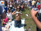 Hot girl flashing her nice tits on the grass at a rockfest