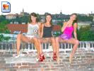 Three hot young teens sitting on a wall, flashing their pussies at the camera