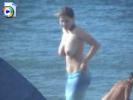 Topless teenie shows off her huge tits at the beach