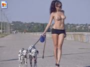 Insanely hot brunette walks her doggies with barely any clothes