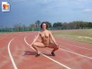 Sexy girl shows off her snatch and titties at an athletics track