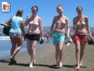 3 Topless teen girls walk around on the beach