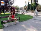 Slender brunette shows off her snatch on a park bench