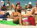 Hot exotic cutie caught sunbathing with her tits out
