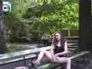 Crazy brunette sitting on a park bench, fucking her pussy with a vibrator