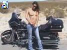 Sexy biker slut strips on the side of the road