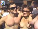 Various people going topless at a huge street event