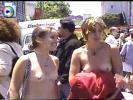 Sexy young lesbian lovers go topless at a lesbo-rally in the city