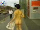 Kinky short haired chick tries to give away free newspapers while in the nude!