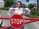 Young brunette chick encouraging people to pay attention to the stop sign!
