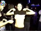 Drunk young raver chick flashes her titties and makes them bounce at a rave
