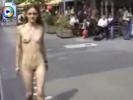 Skinny teen girl walks through a city with no clothes on