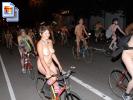 Group of naked people ride their bikes in the nude at night