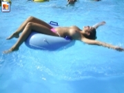 Topless girl feeling free in public pool