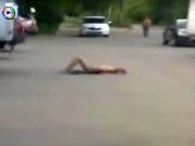 Confused woman sunbathing naked in the suburbs