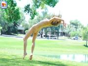 Girl doing naked cartwheels at the park