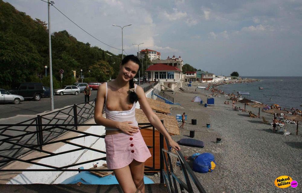 Tiny titted cutie chilling at the beach