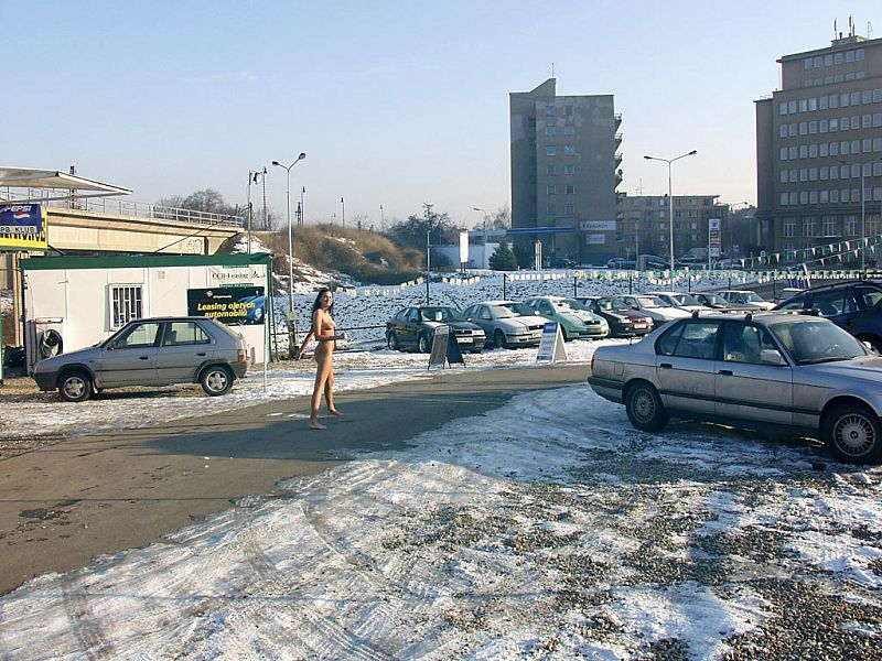 Sexy German girl posing fully nude on a snowy car park