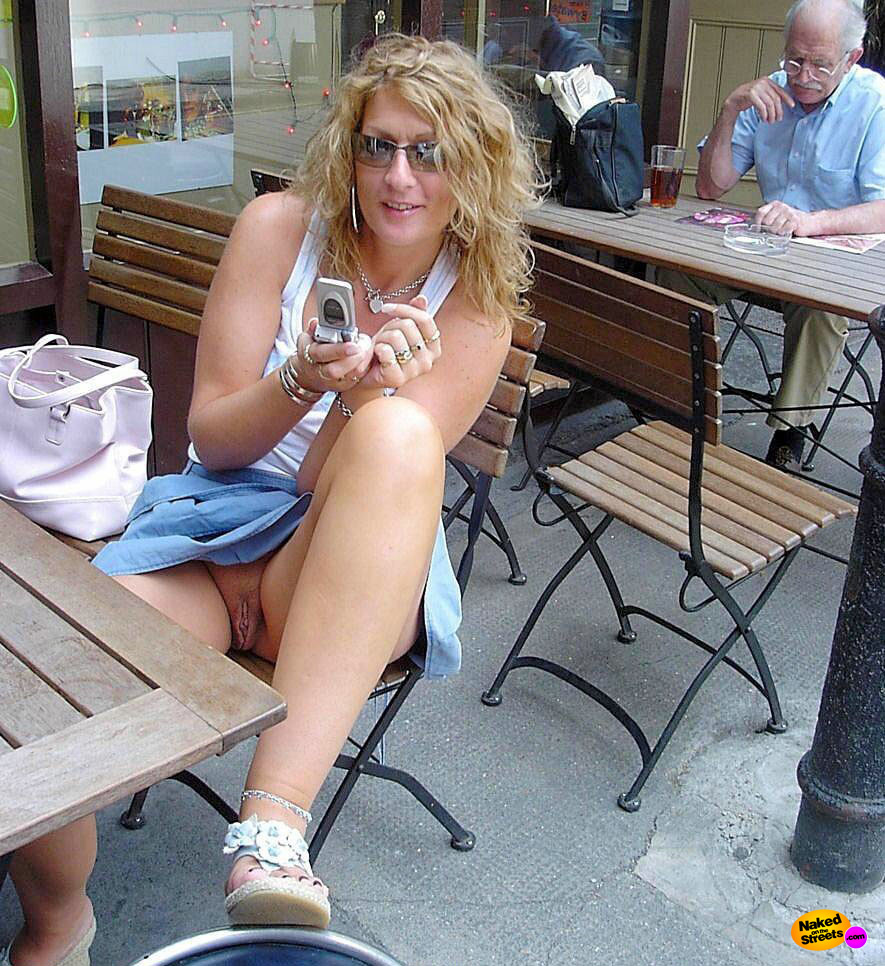 Curly haired blonde girl shows her snatch in public