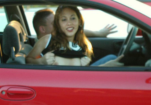 Horny amateur bitch in a car flashing tits and ass