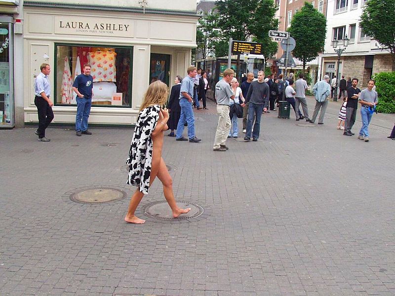 Crazy blonde slut walks through town wearing nothing at all