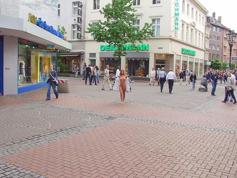 Crazy blonde slut walks through town wearing nothing at all