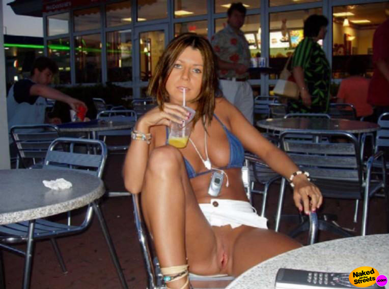 Hot girl shows her snatch on a public terrace 