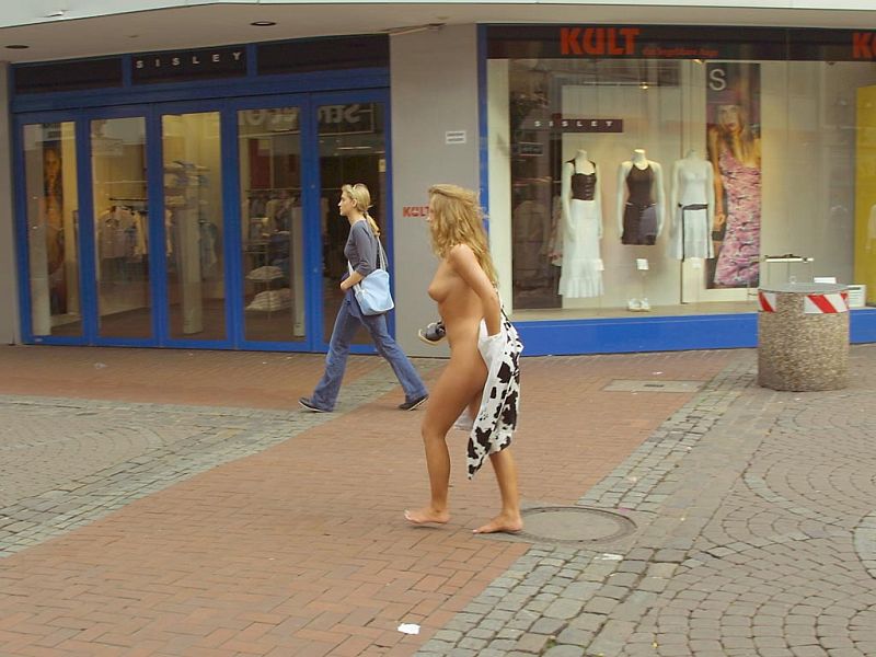 Crazy blonde slut walks through town wearing nothing at all