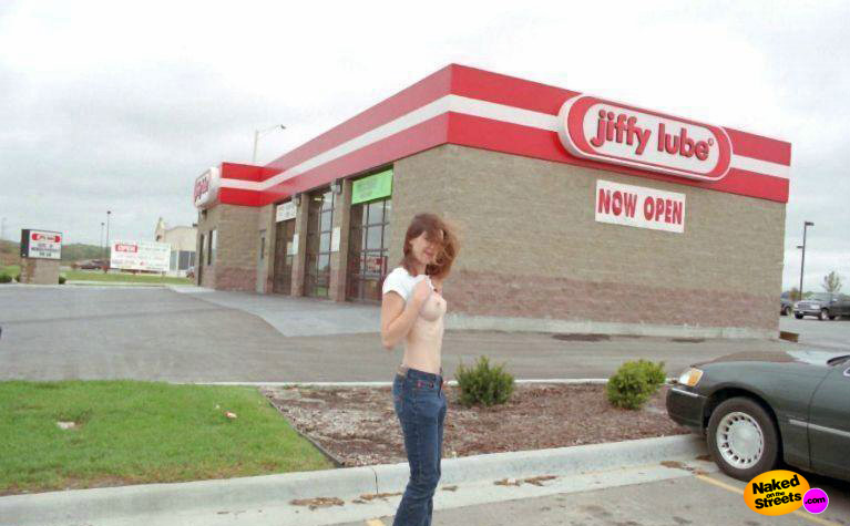 Naughty girl flashes in front of Jiffy Lube