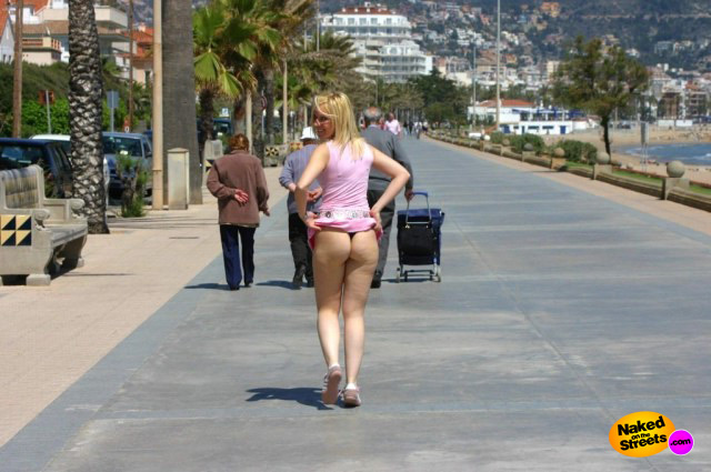 Naughty girl flashing her booty on the promenade