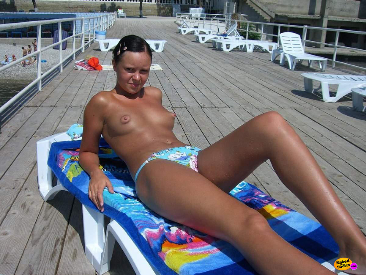 Teen hottie sunbathing topless at the lake