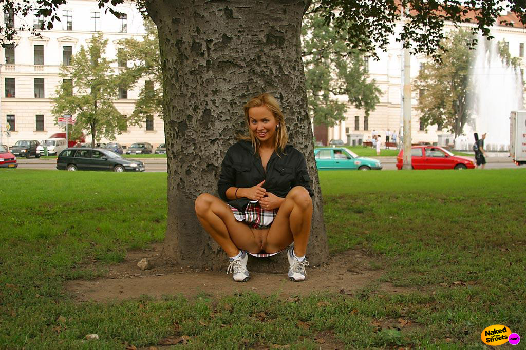 Sexy college girl shows her snatch under a tree