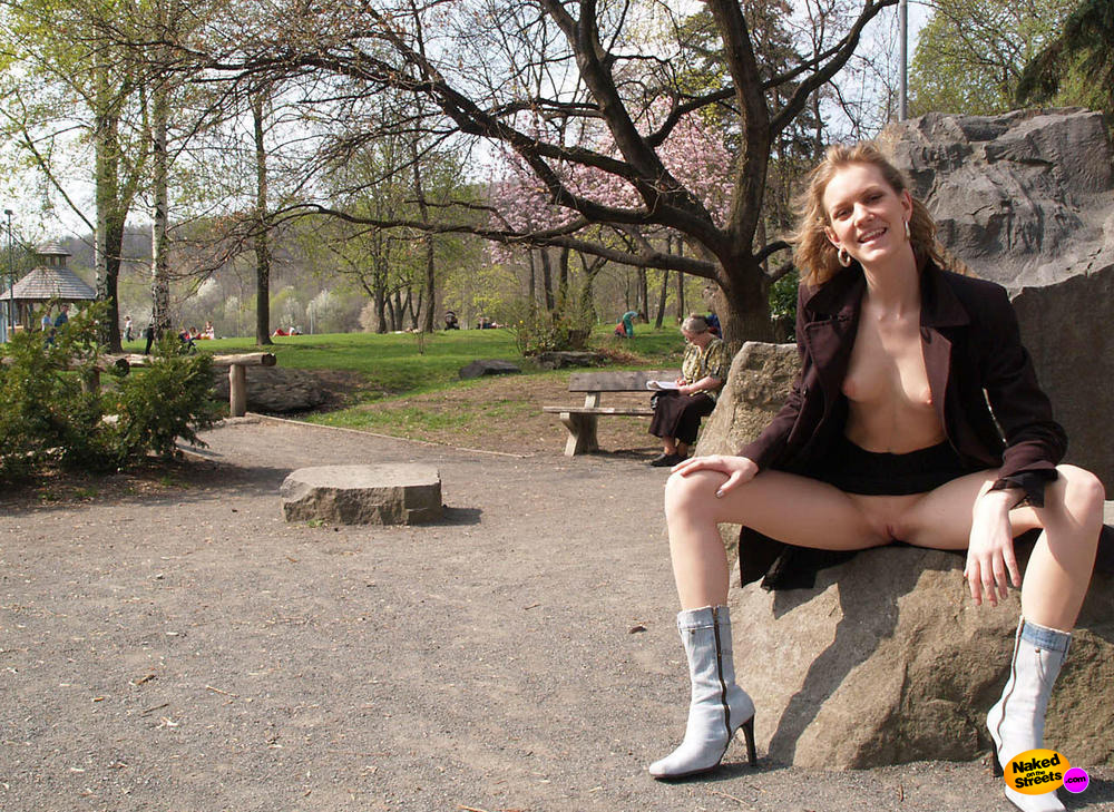 Laughing girl shows her snatch in the park