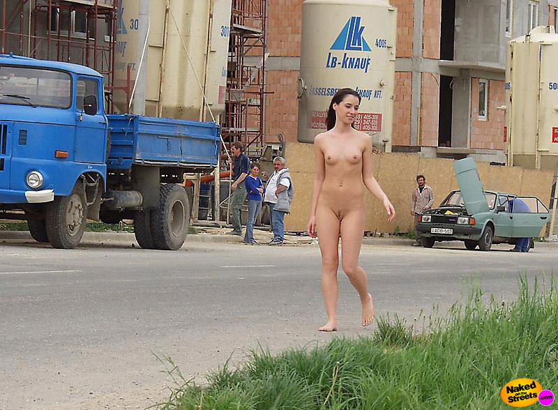 Sexy teen girl walks past a construction site with no clothes on