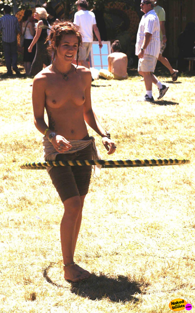 Crazy sexy chick hoolahooping topless in a public park